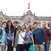 students pose in front of ornate building