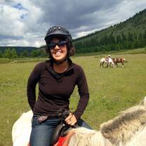 student smiling on horseback