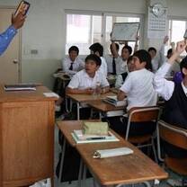 students in white uniform in classroom
