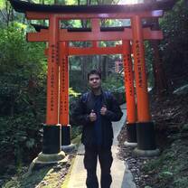man standing under Japanese arch
