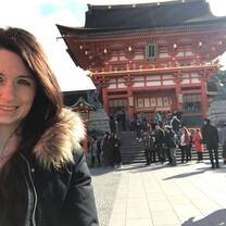 girl smiling in front of a Japanese building