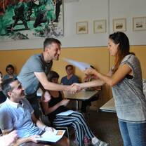Male student shakes female teacher's hand