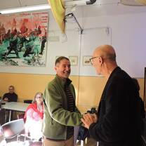 Two males shake hands