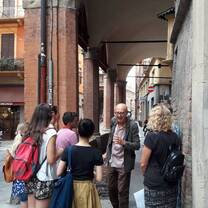 Group of male and female students take a tour in Bologna, Italy