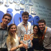group of people in front of a sign at a conference