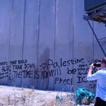 A student photographs the barrier that divides Israel and the West Bank