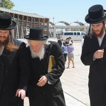 Hasidic men go to pray at the Western Wall in Jerusalem