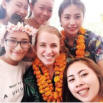 five women wearing Hawaiian flower