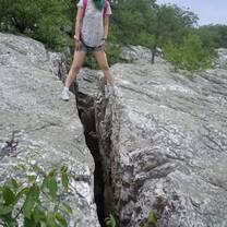 A girl standing on the two rock 