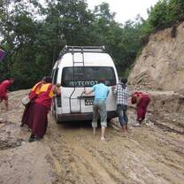 Group of people pushing the car