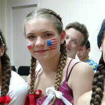 three ladies with a flag paint on their face