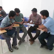 Four men talking while sitting