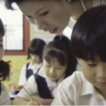 The lady teach the two students