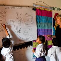 students writing on whiteboard in nepal