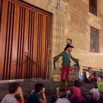 a man storytelling in front of a group of children