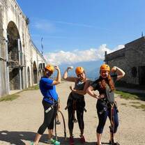 Three people in helmets striking pose with strong arm pose
