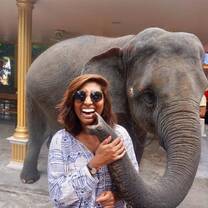 girl smiling in thailand with elephant