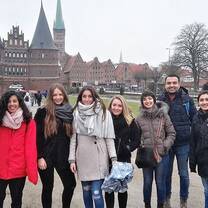 Group of students outside a castle-like building.