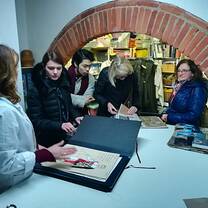 A lady showing some people portfolios.