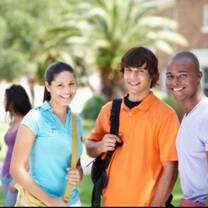 young lady in blue shirt with two young boys in orange and white