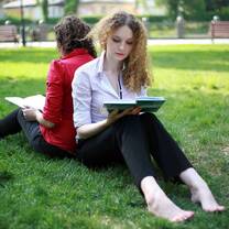 Two women each reading a book.