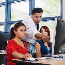 man and woman work on a computer