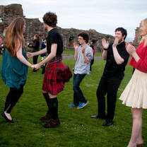 group dancing on green grass