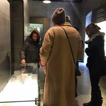 group of people looking at something  inside the glass