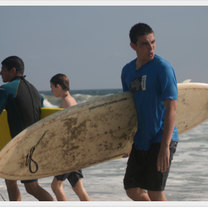 Guys with surfboards at the beach.