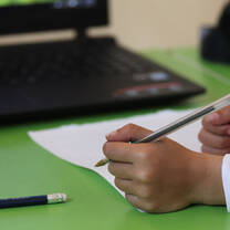 hands holding a pen and a paper