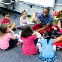young man playing with the little kids