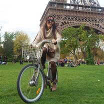 Student on bike by Eiffel Tower