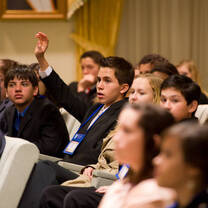 the guy raising his hands to ask or answer