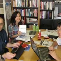 Three people busy with their laptops