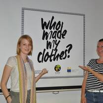 two girls showing whats on the board
