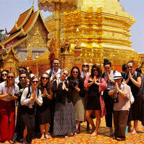 group outside of gold monument in Thailand