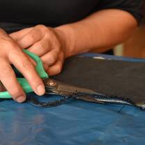 Closeup of someone cutting fabric