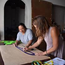 Huaywasi intern assisting Elena with design work.