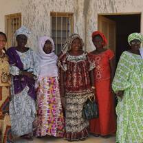 Women standing together wearing traditional clothing. 