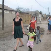 Female students walking with school children. 