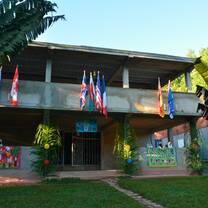 Front view of main building at the field site, flags from around the world displayed