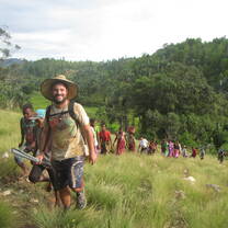 Volunteers climbing hillside