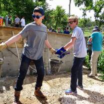 Passing buckets of cement to build a retaining wall in Puerto Rico