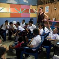 A volunteer teaching a special English class with the elementary school kids