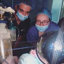 Myself and one of my friends, who was on placement for medicine, observing a newborn who we just received out of theatre from a c-section. 