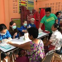 Team members are checking the blood sugar levels of Thai patients. 