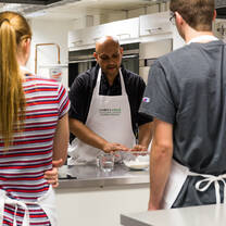 Teenagers listening to chef