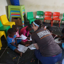 A volunteer from the education project with young children