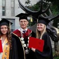 Taking pictures in front of campus next to the steel elk