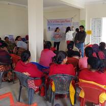 Volunteers teaching about domestic violence to a group of local women at a women's center
